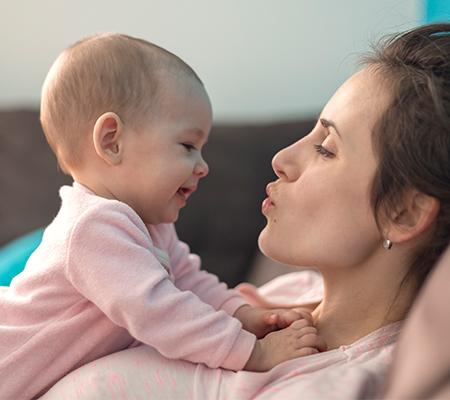 Photo of a baby and mom interacting