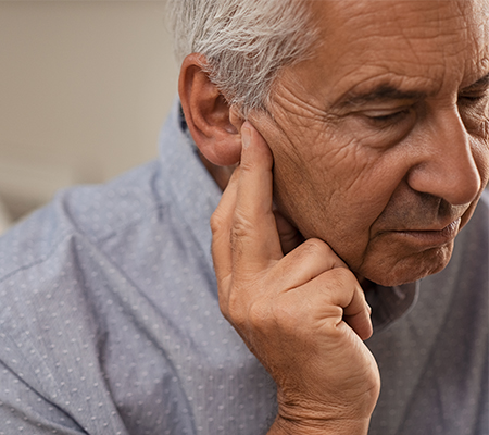 A close-up image of a man looking off screen.