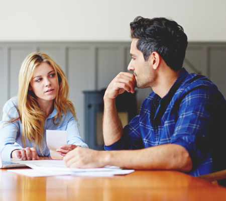 husband and wife completing important documents including last will and testament, financial power of attorney and advance care directive
