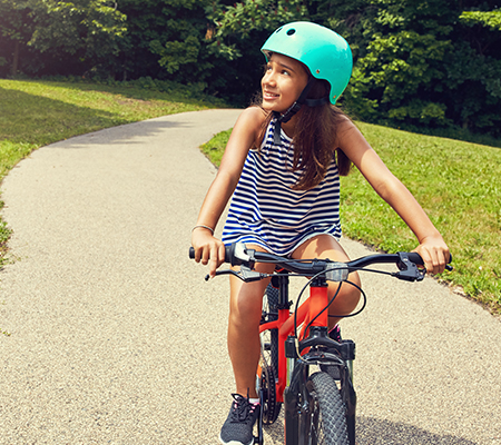 A girl rides her bike.