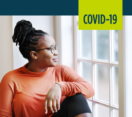 A woman looks out a window.