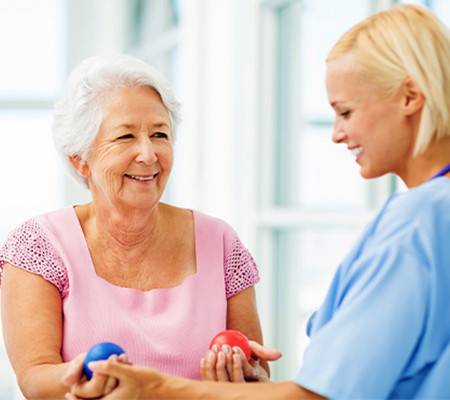 occupational therapy session where woman is holding a ball