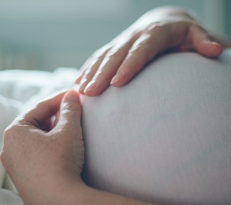 Image of pregnant lady holding her belly