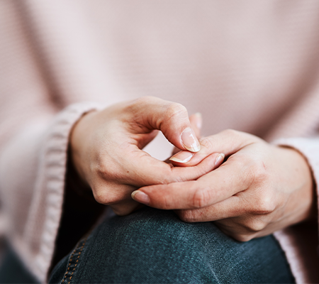 Image of woman holding her finger - trigger finger