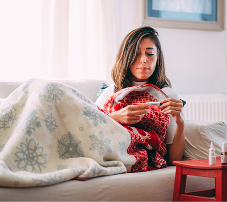 Image of woman looking at his temperatue