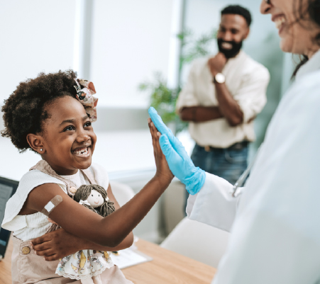 kid high-fiving doctor after appointment for catching up on missed vaccinations
