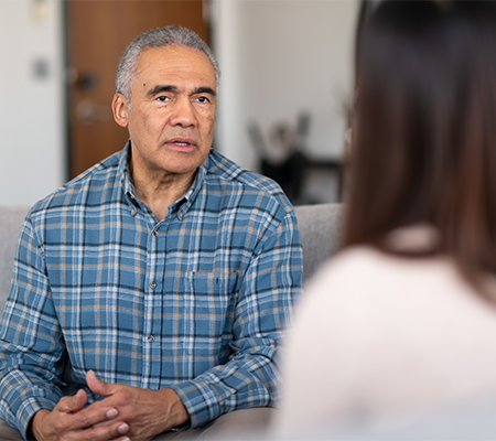 speech language pathologist talks to patient with head and neck cancer about swallowing issues