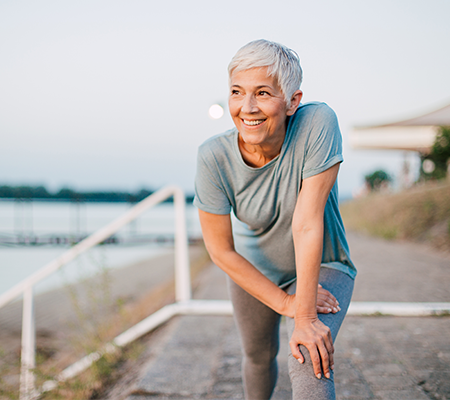 Woman leaning over outside