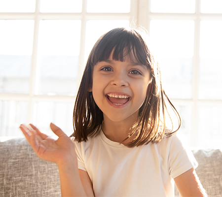 Young girl smiling and living with vocal cord dysfunction