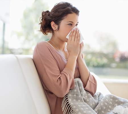 Sick woman wondering if she should get her flu vaccine
