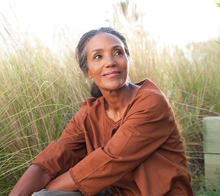 woman sitting in field wondering if she should get a microvascular reconstruction surgery