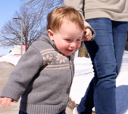 Mom seeking care for her child and holding his hand