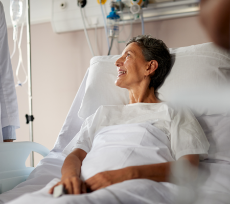 women sitting in hospital bed in a swing bed program