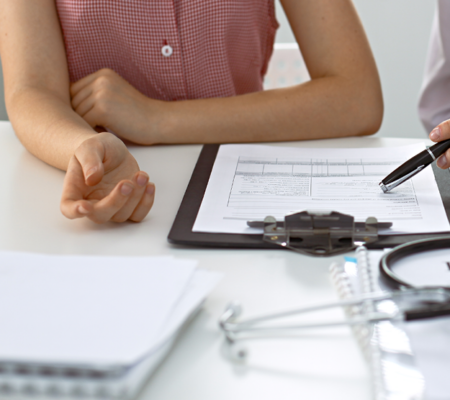 Photo of hands of a doctor and patient discussing common lab results. 